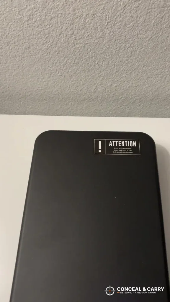ATTENTION label on the lid of the Grimtron portable car gun safe