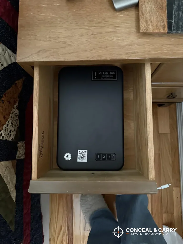 Grimtron car gun safe sitting in an open wooden drawer