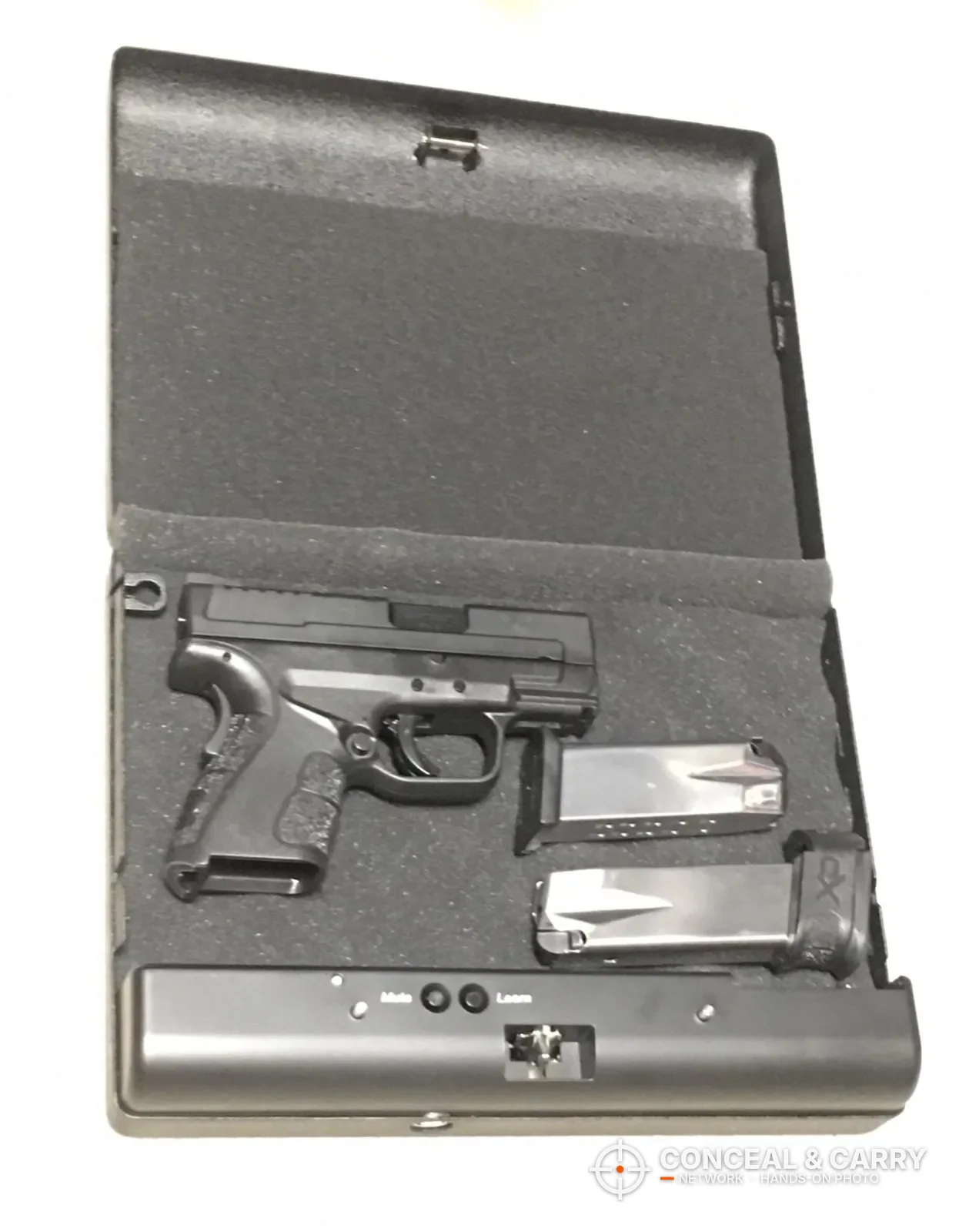 GunVault MV500 open with a compact pistol and two magazines in the foam