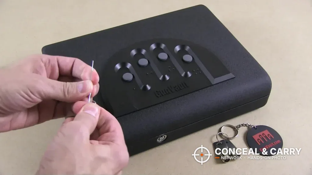 GunVault MV500 closed with two keys and a key fob beside it