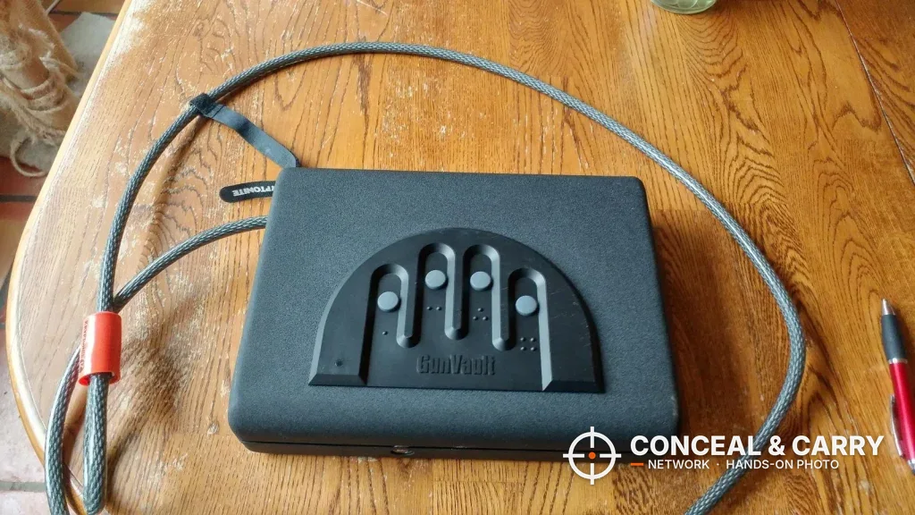 GunVault MV500 on a wooden table with a steel security cable