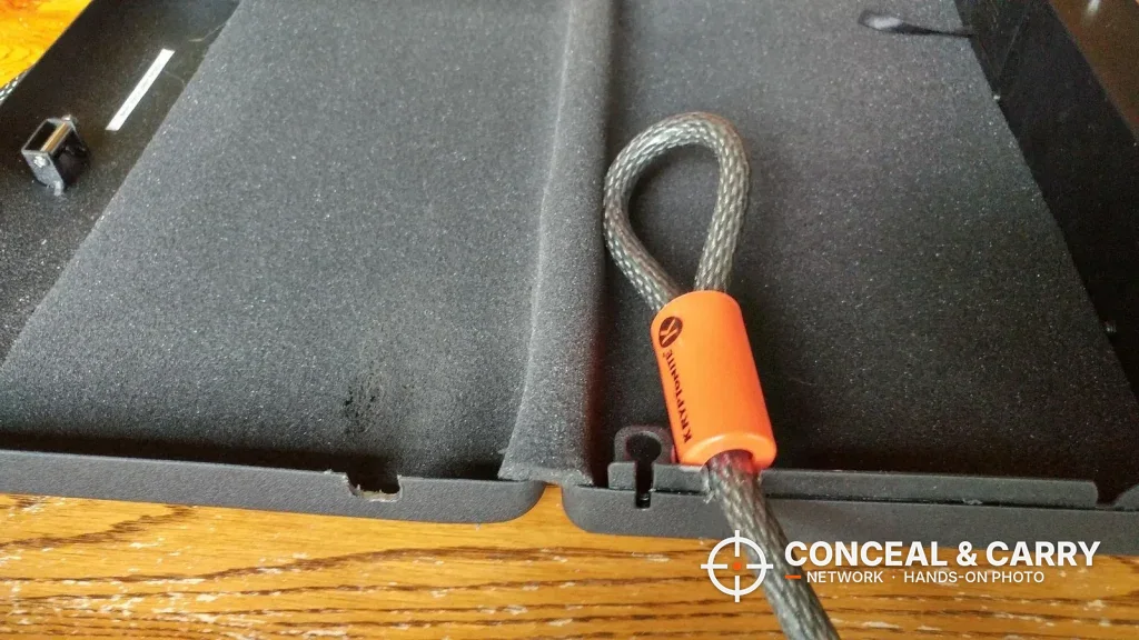 Security cable loop passing through a slot in the open GunVault MV500