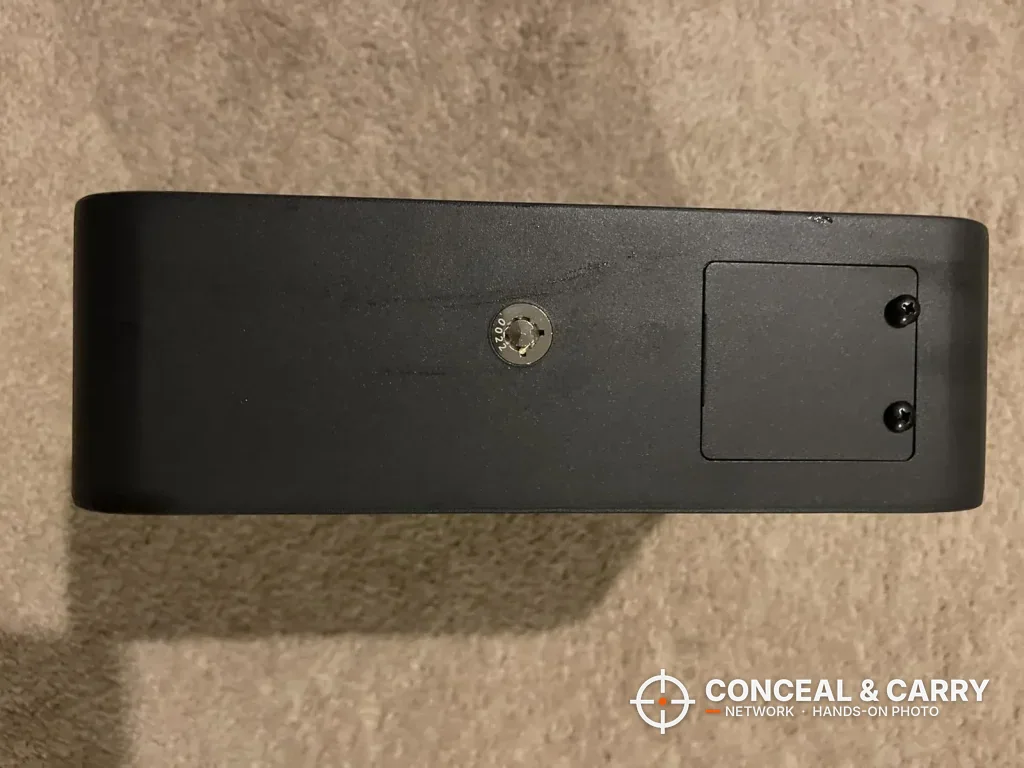 HOLEWOR slider safe housing turned to show the key lock and a screw-on cover plate