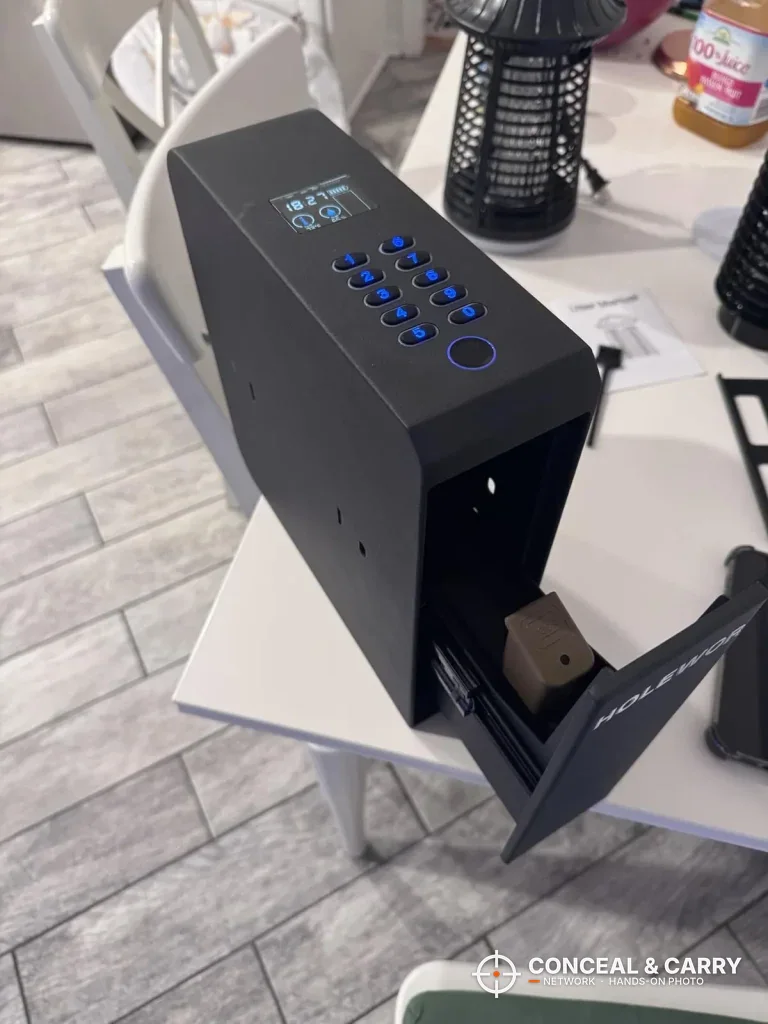 HOLEWOR slider safe on a table with the drawer open and the keypad lit blue