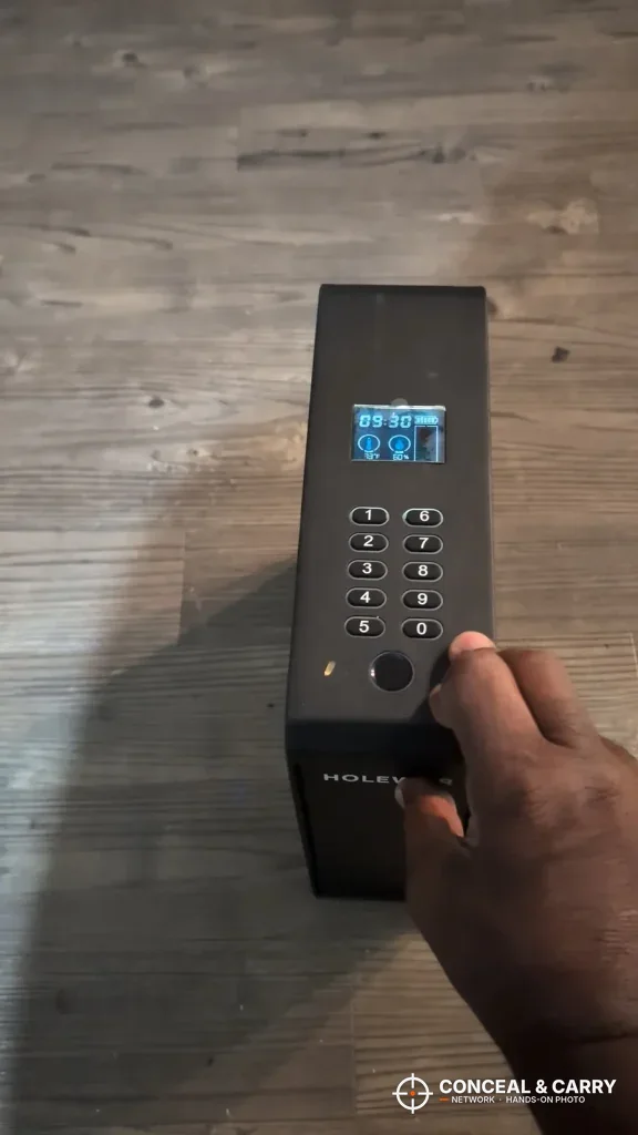 Finger on the HOLEWOR slider safe fingerprint reader below the keypad