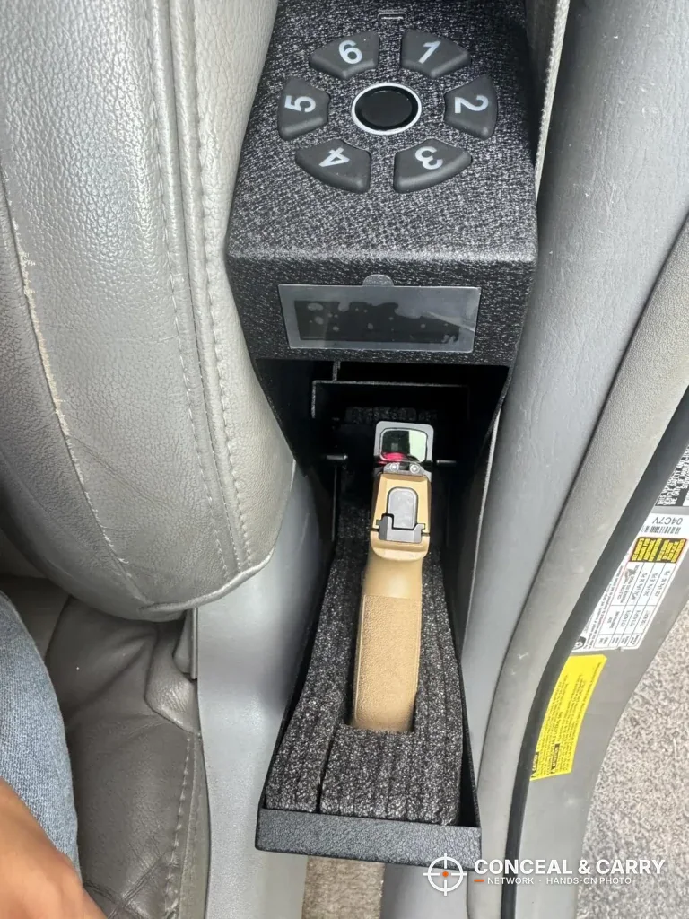Pistol with a tan grip in the foam cradle of the open HOLEWOR drop-down safe