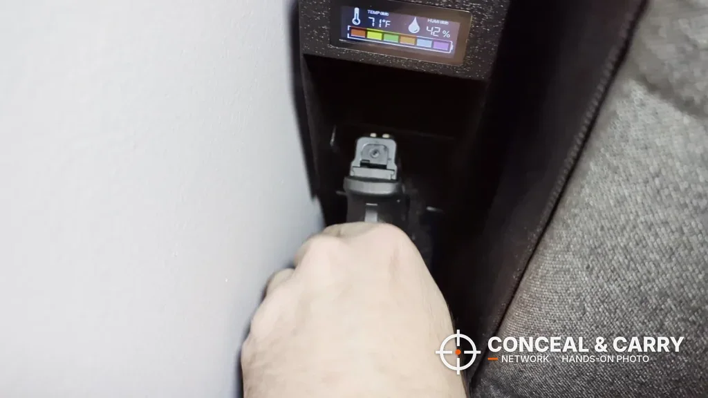 Hand drawing a pistol from the open HOLEWOR drop-down safe