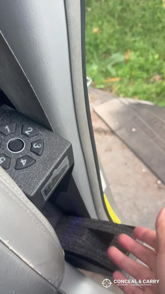 HOLEWOR drop-down safe door hanging open beside a car seat