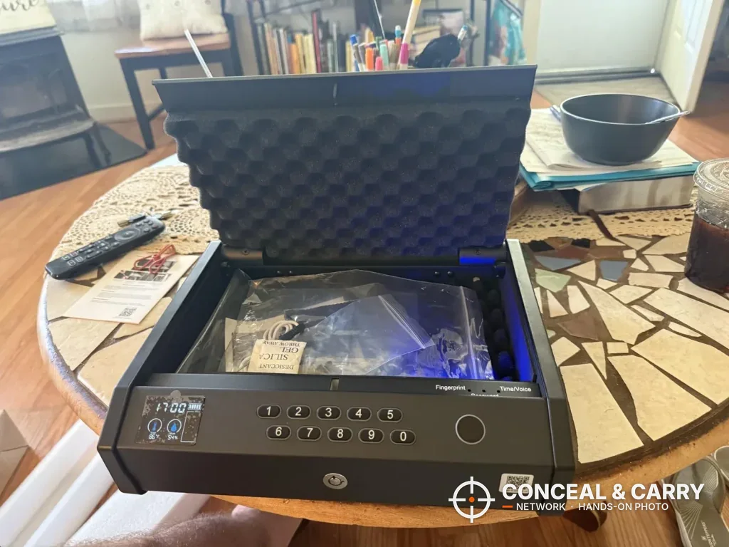 Ten-button HOLEWOR handheld safe open on a table with the interior light on