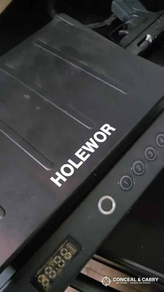 Angled close-up of the HOLEWOR handheld safe lid, fingerprint reader and display