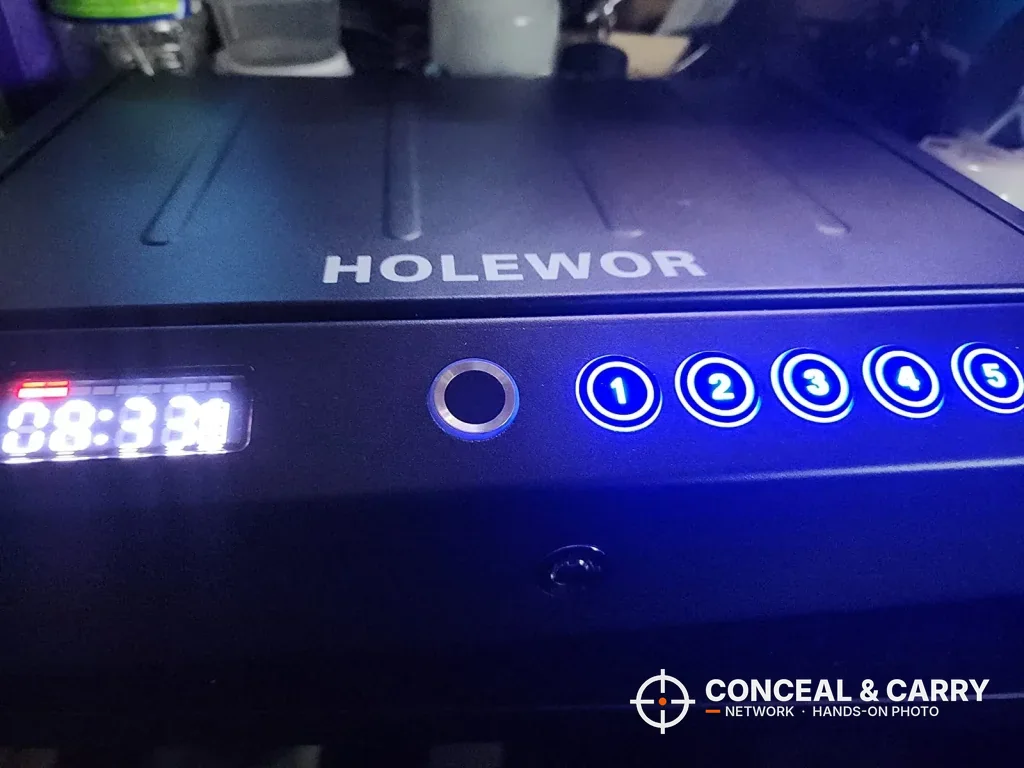 HOLEWOR handheld safe front panel glowing blue in the dark with the clock showing