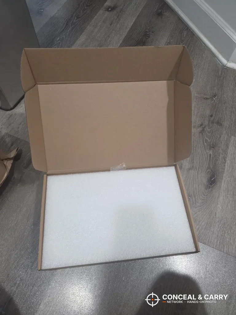 HOLEWOR lock box shipping carton opened with a white foam sheet inside