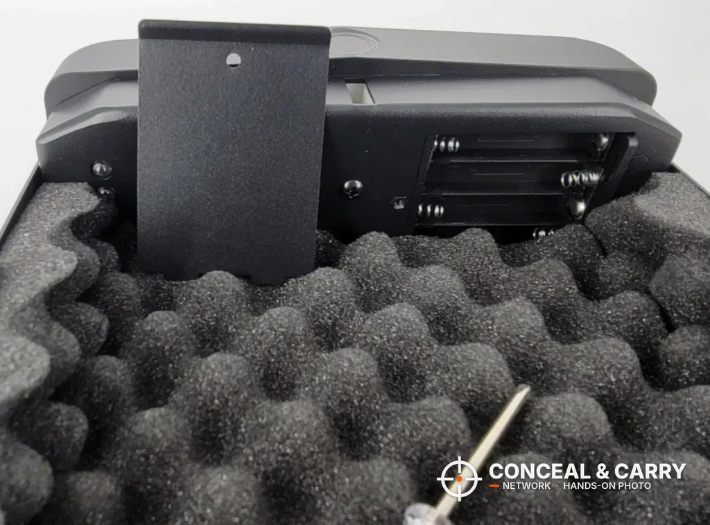 HOLEWOR lock box battery compartment open with a small screwdriver on the foam
