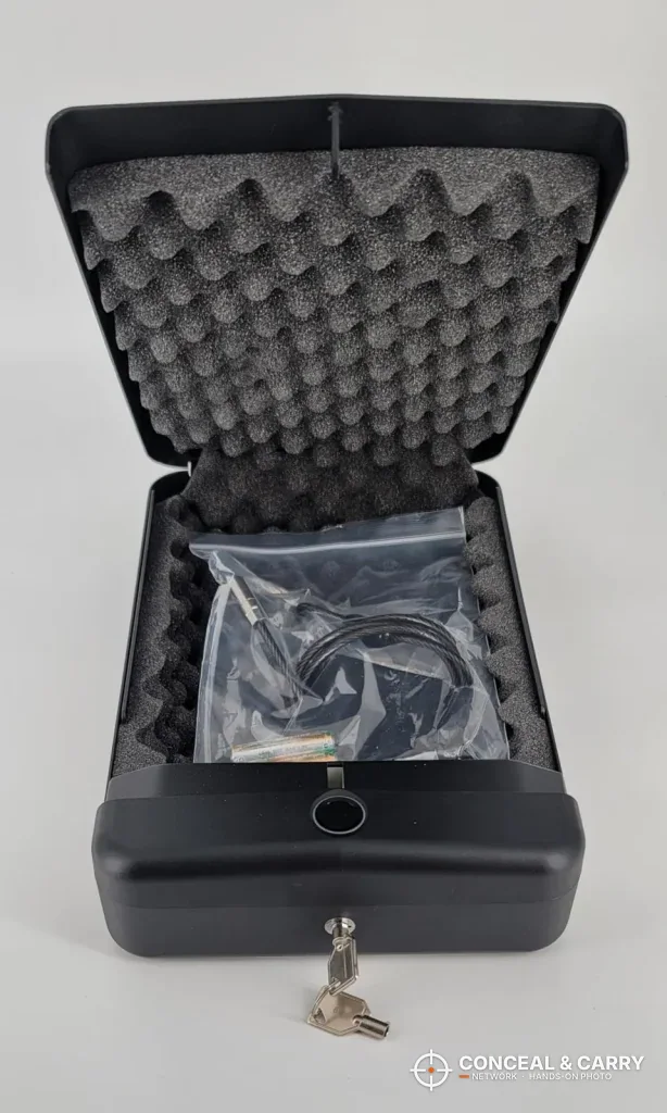 HOLEWOR lock box open with the key in the lock and the parts bag on the foam