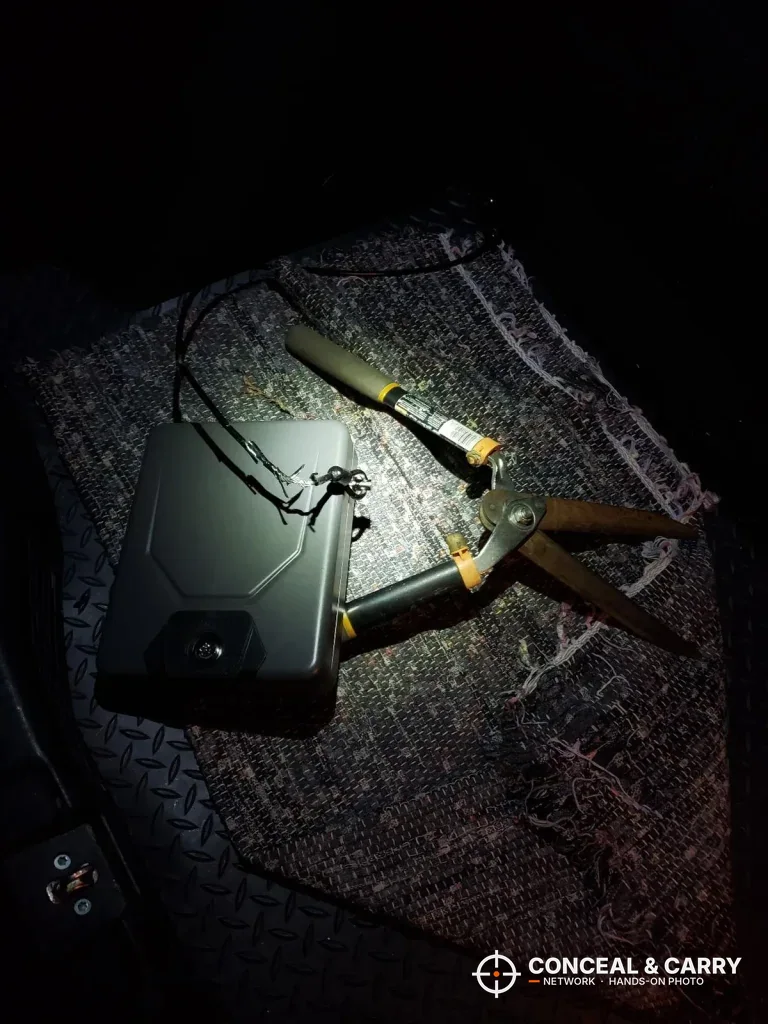 Hornady Lockbox and cable lit by a flashlight in the dark