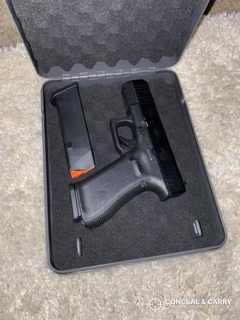 Hornady Lockbox open with a compact pistol and spare magazine on the foam