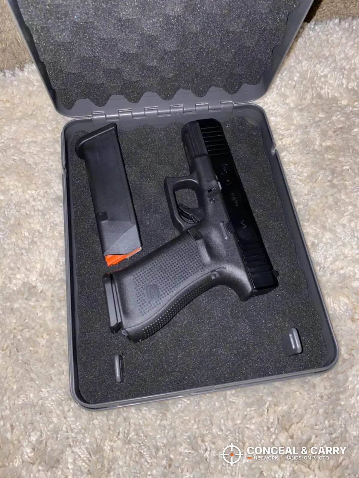 Hornady Lockbox open with a compact pistol and spare magazine on the foam