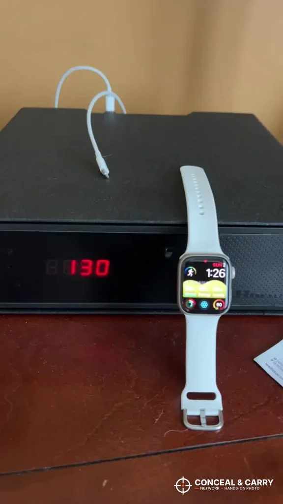Smartwatch and charging cable on the Hornady Night Guard with the clock showing