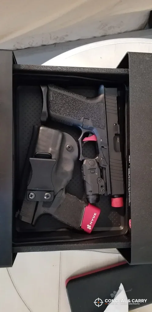 Holstered pistol lying in the open Hornady Night Guard drawer