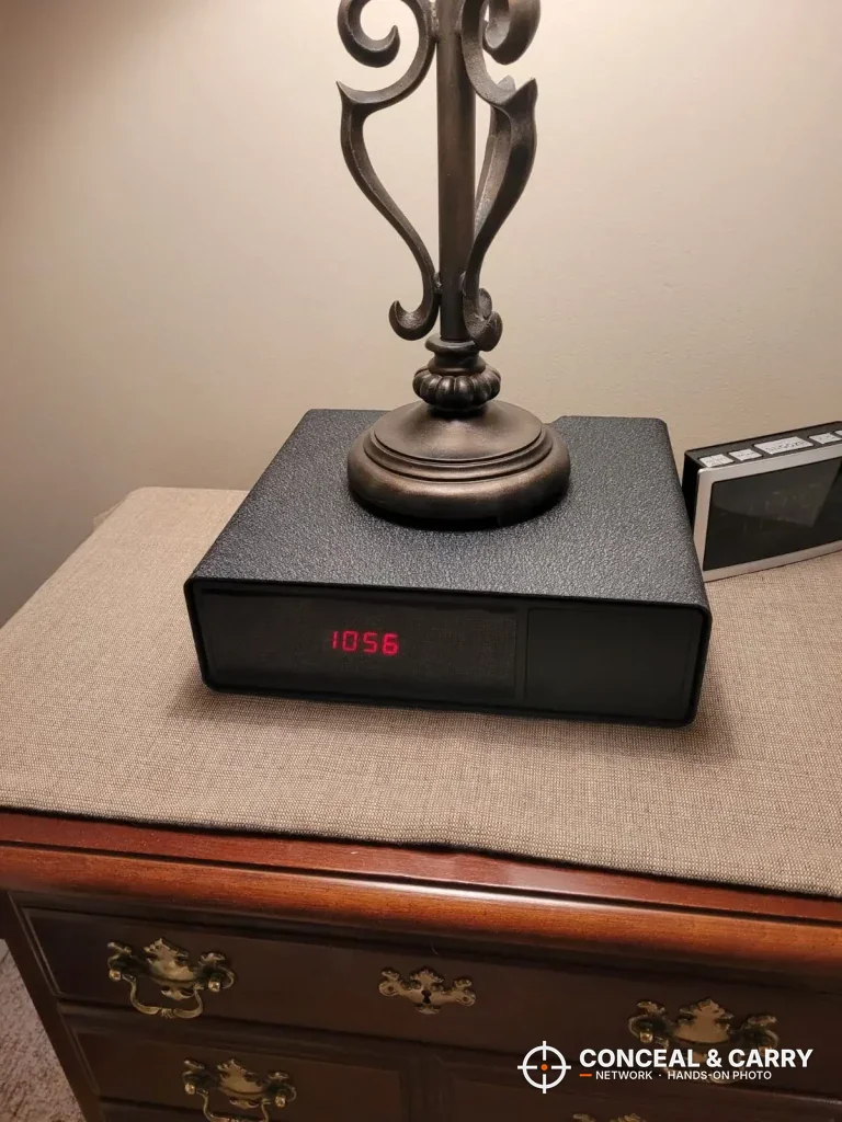 Hornady Night Guard on a nightstand with a lamp sitting on top of it