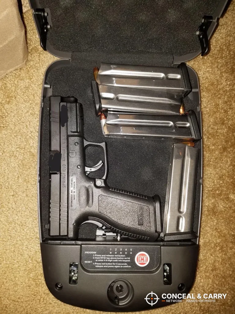 Pistol and spare magazines laid inside the Hornady RAPiD Safe RFID