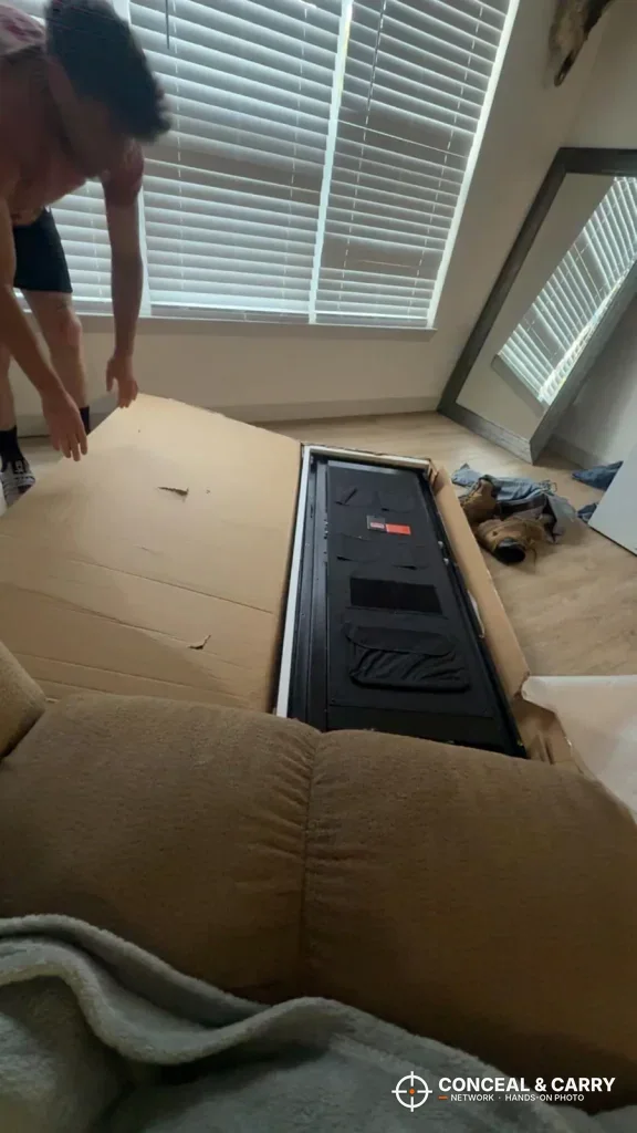 INTERGREAT long gun cabinet in its opened shipping carton on the floor