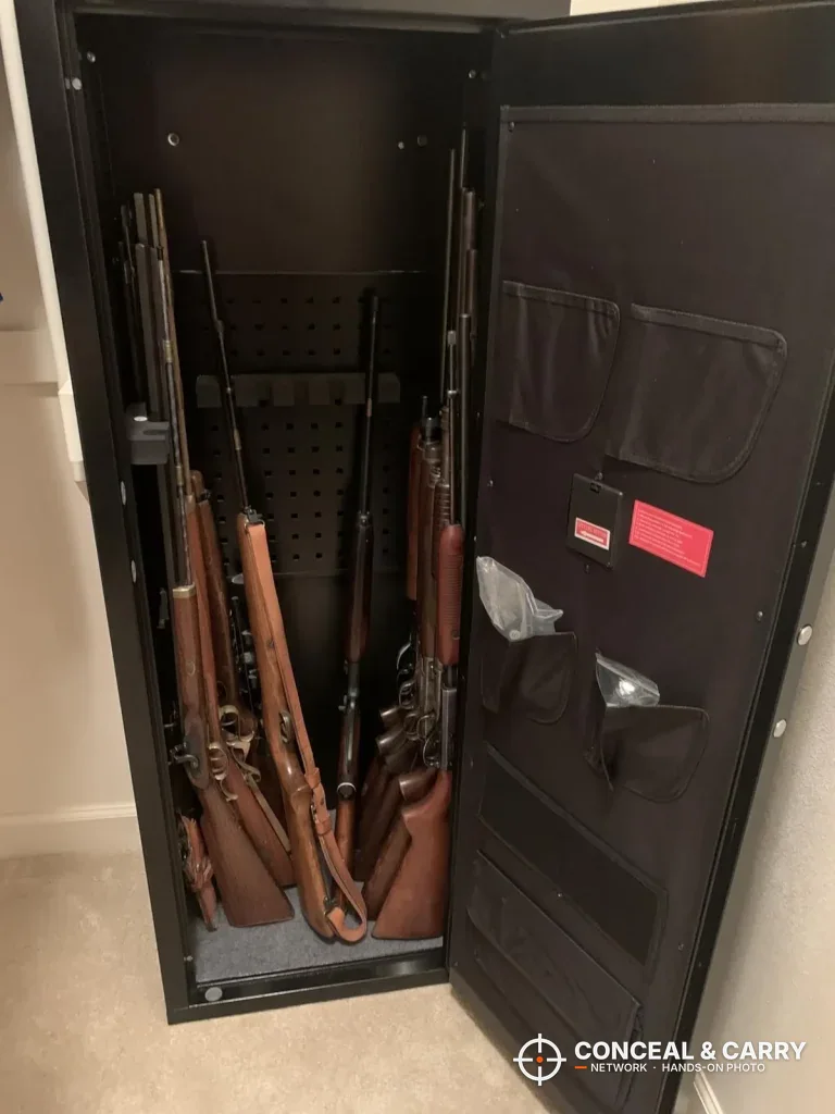 INTERGREAT long gun cabinet open with several wood-stocked rifles standing inside