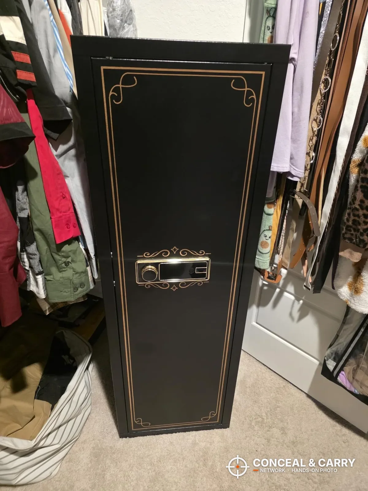KAER 12-15 gun biometric cabinet closed, with gold trim and lock panel, in a closet