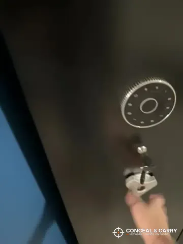 Hand at the lock below the round keypad on a KAER 12-15 cabinet