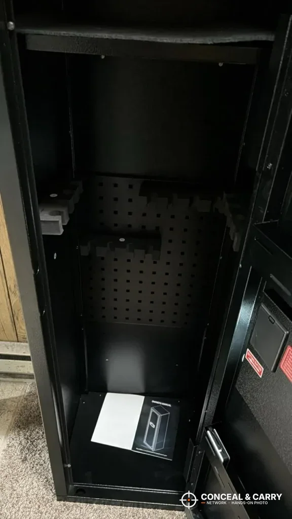KAER 12-15 gun cabinet open and empty, with the manual on the cabinet floor