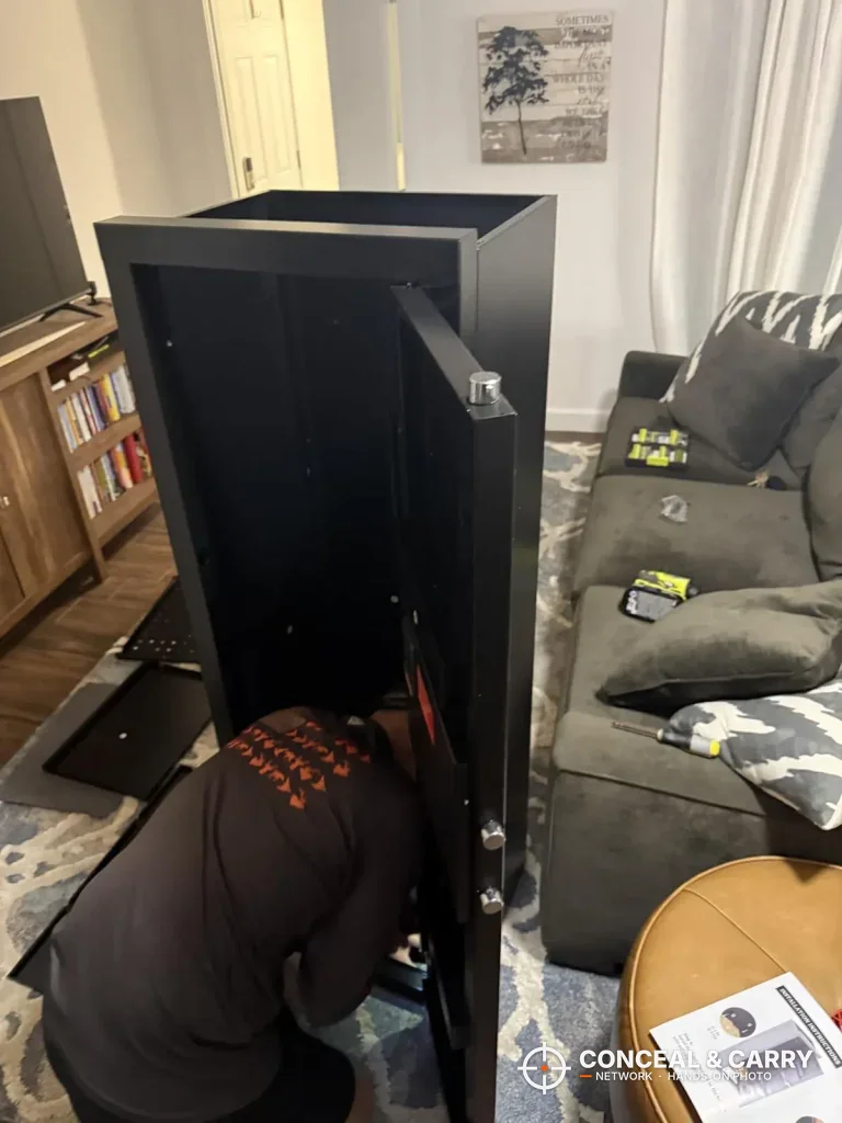 KAER 13-16 gun safe door open during assembly in a living room
