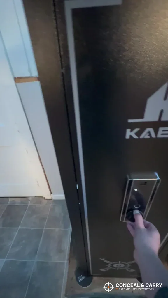 Hand at the lock panel on the KAER 13-16 gun safe