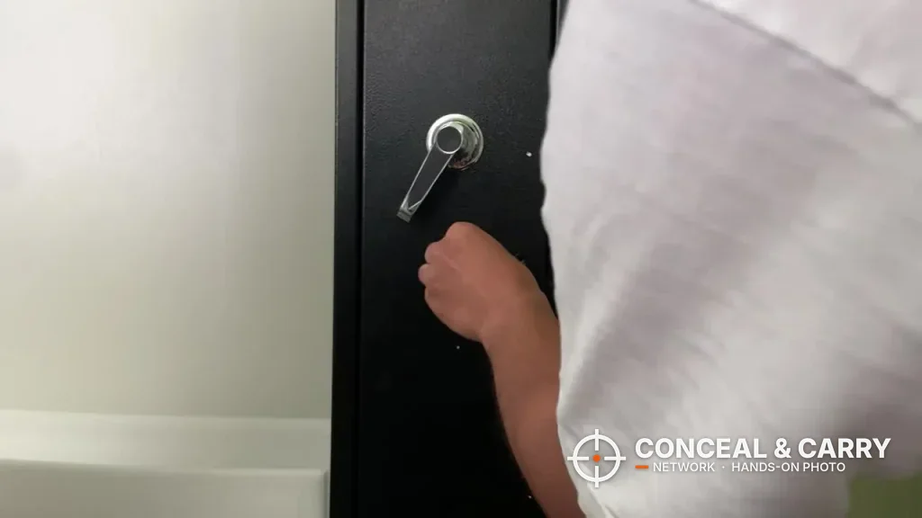 Hand turning the lever handle on the KAER 2-3 gun rifle safe