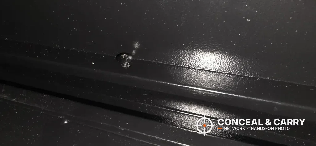 Close-up of the KAER 3-5 gun fingerprint safe black finish and a small fastener