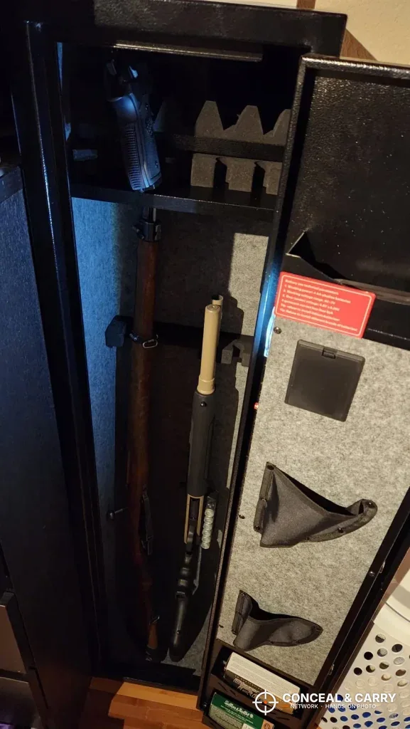 KAER 3-gun rifle safe open with a long gun standing inside and pockets on the door