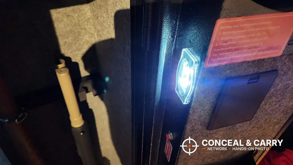 Sensor light glowing inside the open KAER 3-gun rifle safe