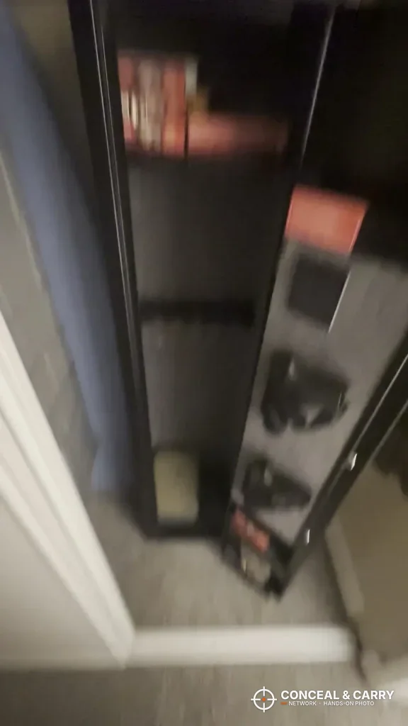 KAER 3-gun rifle safe with the door open in a closet corner