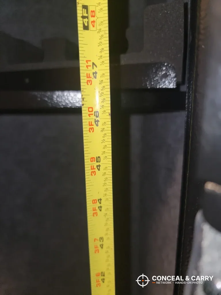 Tape measure checking the inside of the KAER 3-gun rifle safe