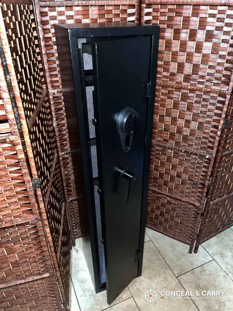 KAER 4-5 gun biometric rifle safe standing closed in front of a woven room divider