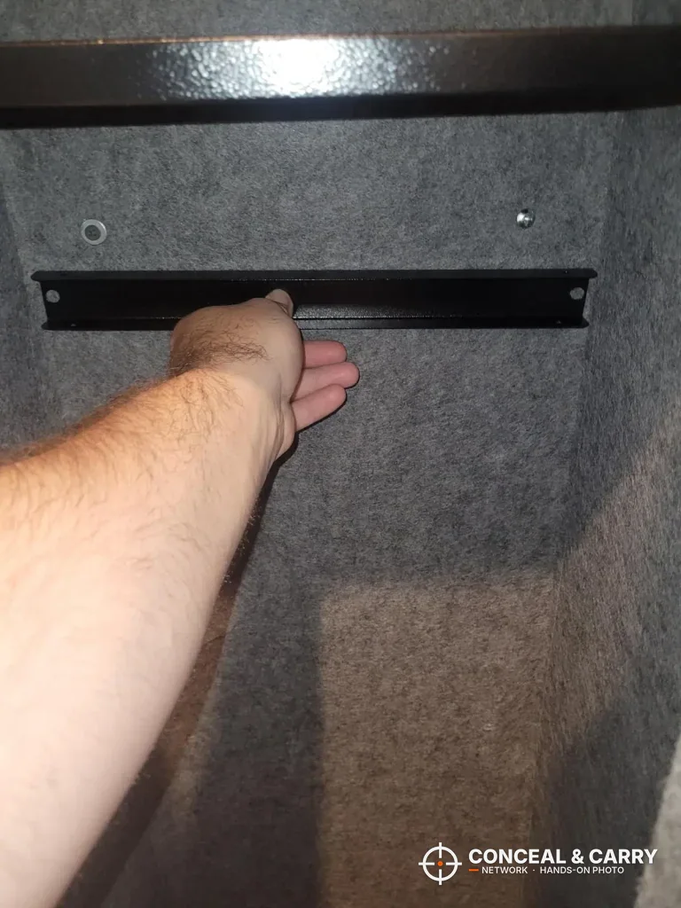 Hand on a rack bar inside the KAER 5-6 gun quick access safe