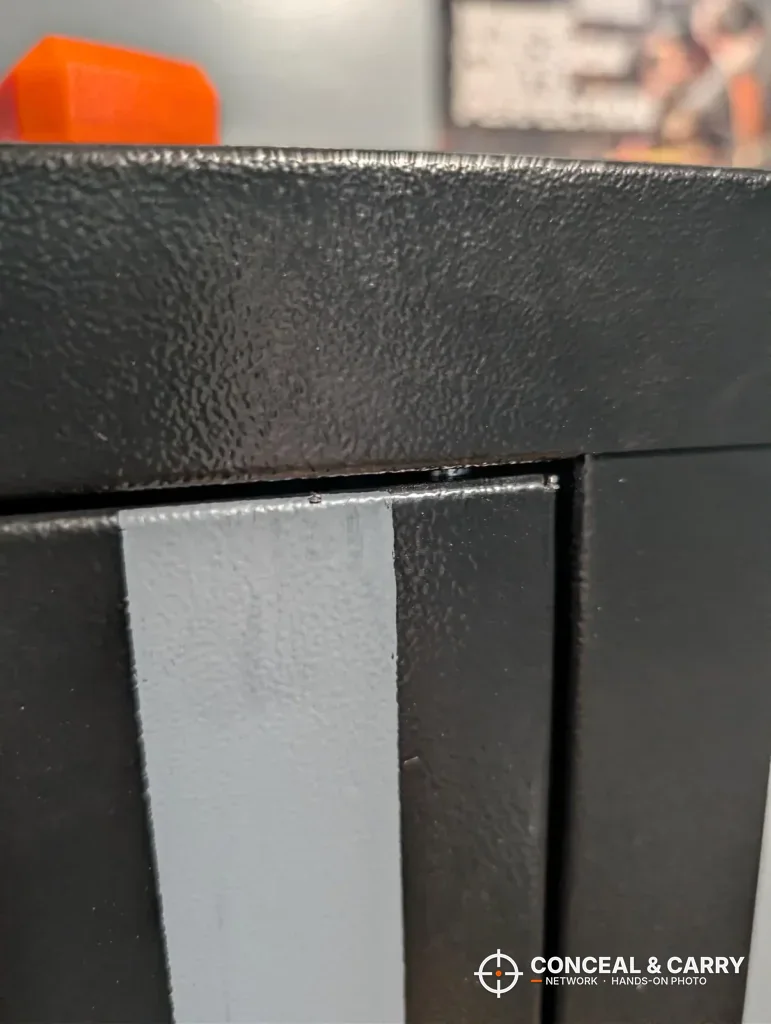Close-up of the KAER 8-12 textured black finish at the top corner of the door