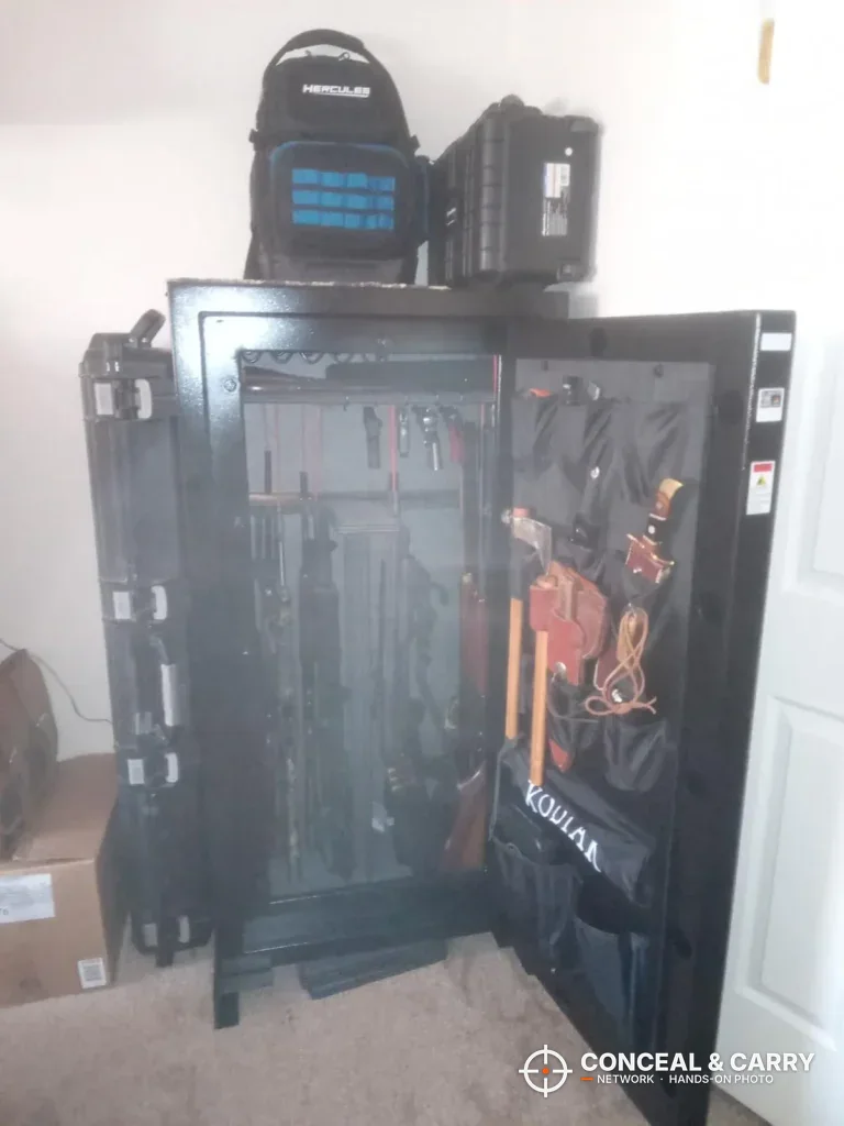 Kodiak KBX5629 open in a room corner, with gear in the door organizer and bags on top