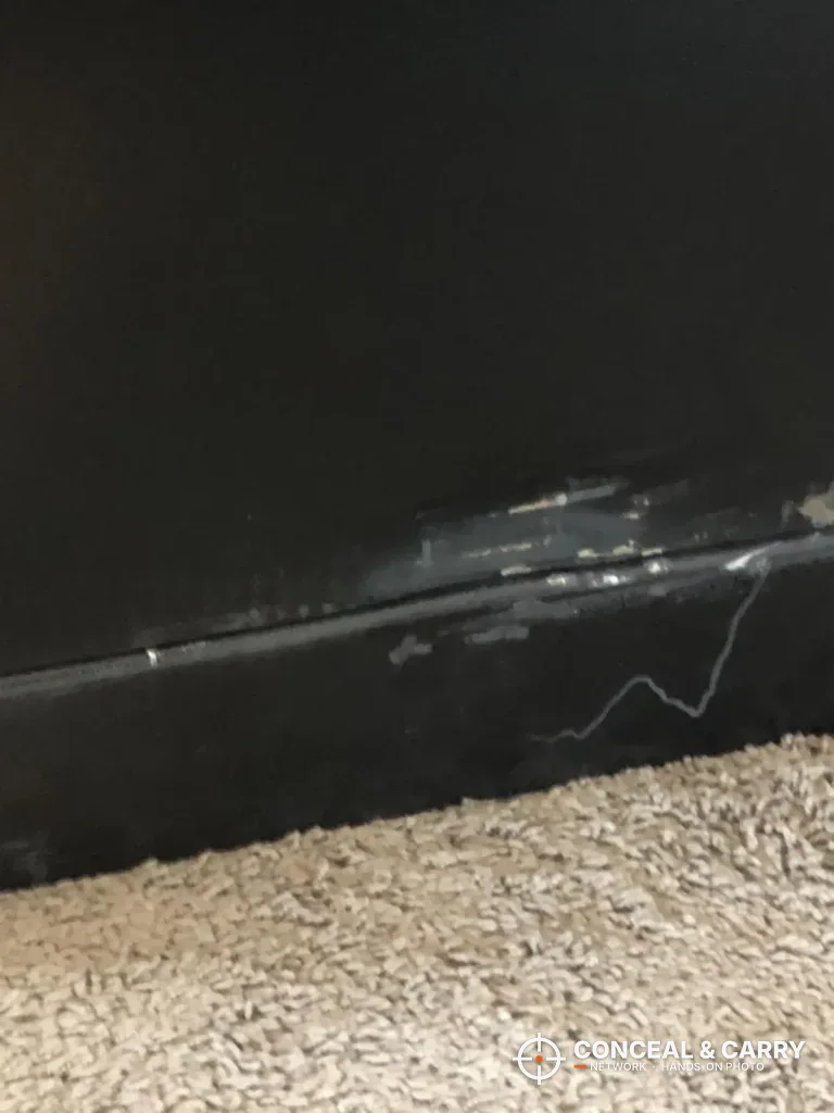 Wider view of the dent near the base of the Kodiak KBX5629 on carpet