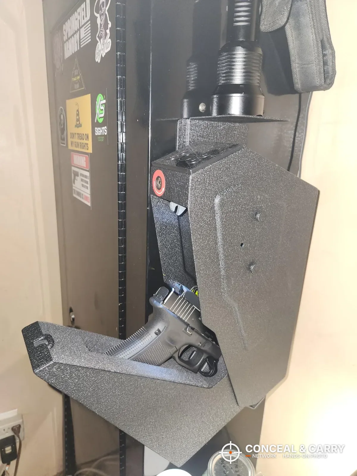 KornerBatl bedside safe mounted on a cabinet with the drawer dropped and a pistol grip showing