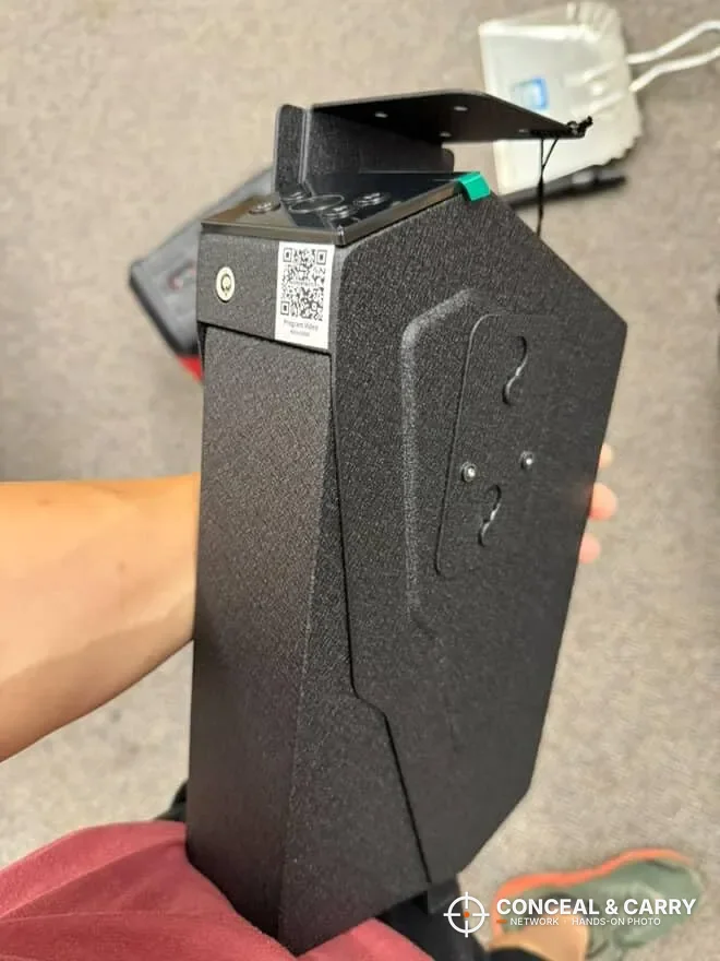 KornerBatl safe held in one hand with the mounting bracket on top
