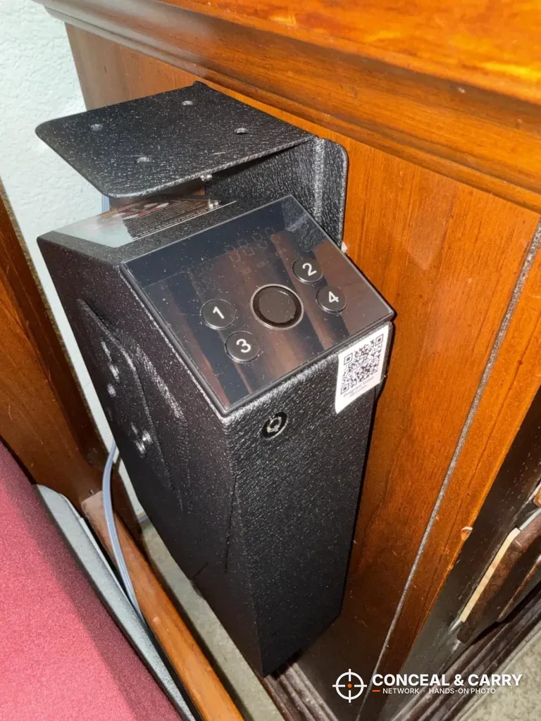 Close-up of the KornerBatl top panel with the round fingerprint reader