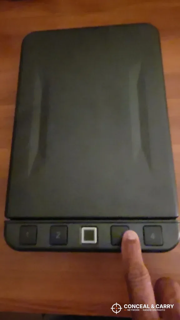 Finger on a keypad button of the closed Langger lock box