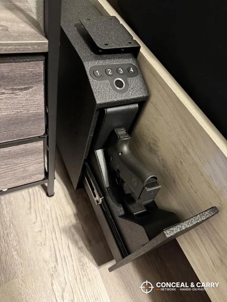 Langger slider safe mounted beside a dresser with the drawer down and a pistol inside