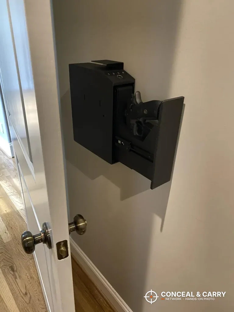 Langger slider safe mounted on a wall by a door with the drawer open on a pistol