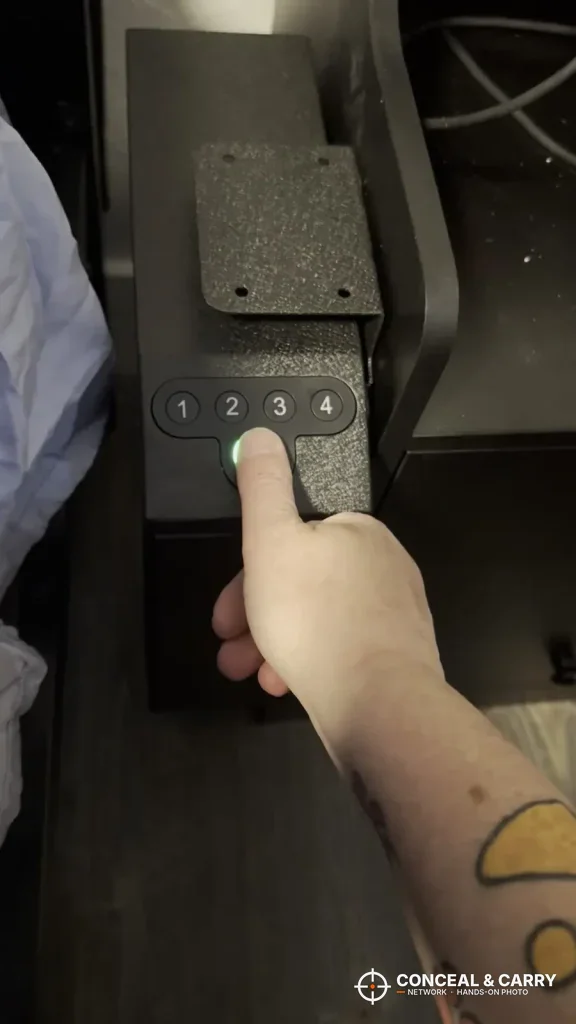 Finger pressing a keypad button on the Langger slider safe